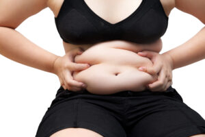 woman squeeze belly fat