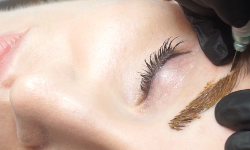 Photo of a woman receiving microblading treatments