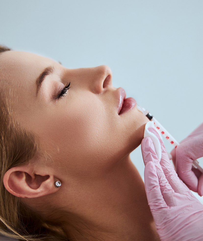 Photo of a woman receiving dermal filler treatments to her lip