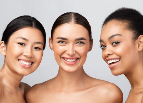 Photo of three smiling, diverse women
