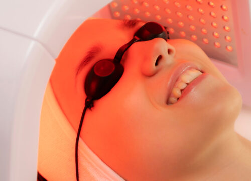 Photo of a woman receiving LED light therapy treatments
