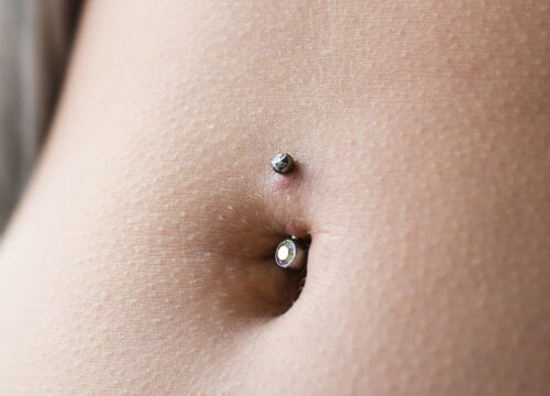 Photo of a woman's belly button piercing