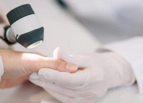 Photo of a dermatologist checking a patient's skin for skin cancer